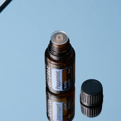 doTERRA Peppermint essential oil bottle pour demonstrates easy drop dispensing.
