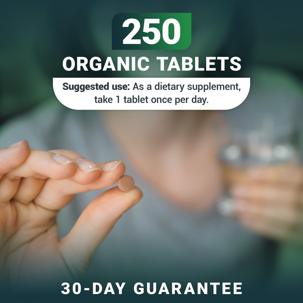 Several Dr. Berg's Greens tablets stacked together on a clean surface.