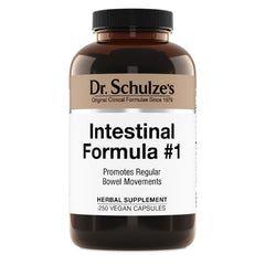 Dr. Schulze's Intestinal Formula #1 bottle pour shows plant-based bowel support for daily wellness.