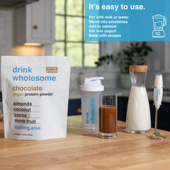 Pouring Drink Wholesome vegan chocolate almond protein powder into glass, dairy-free and gluten-free.