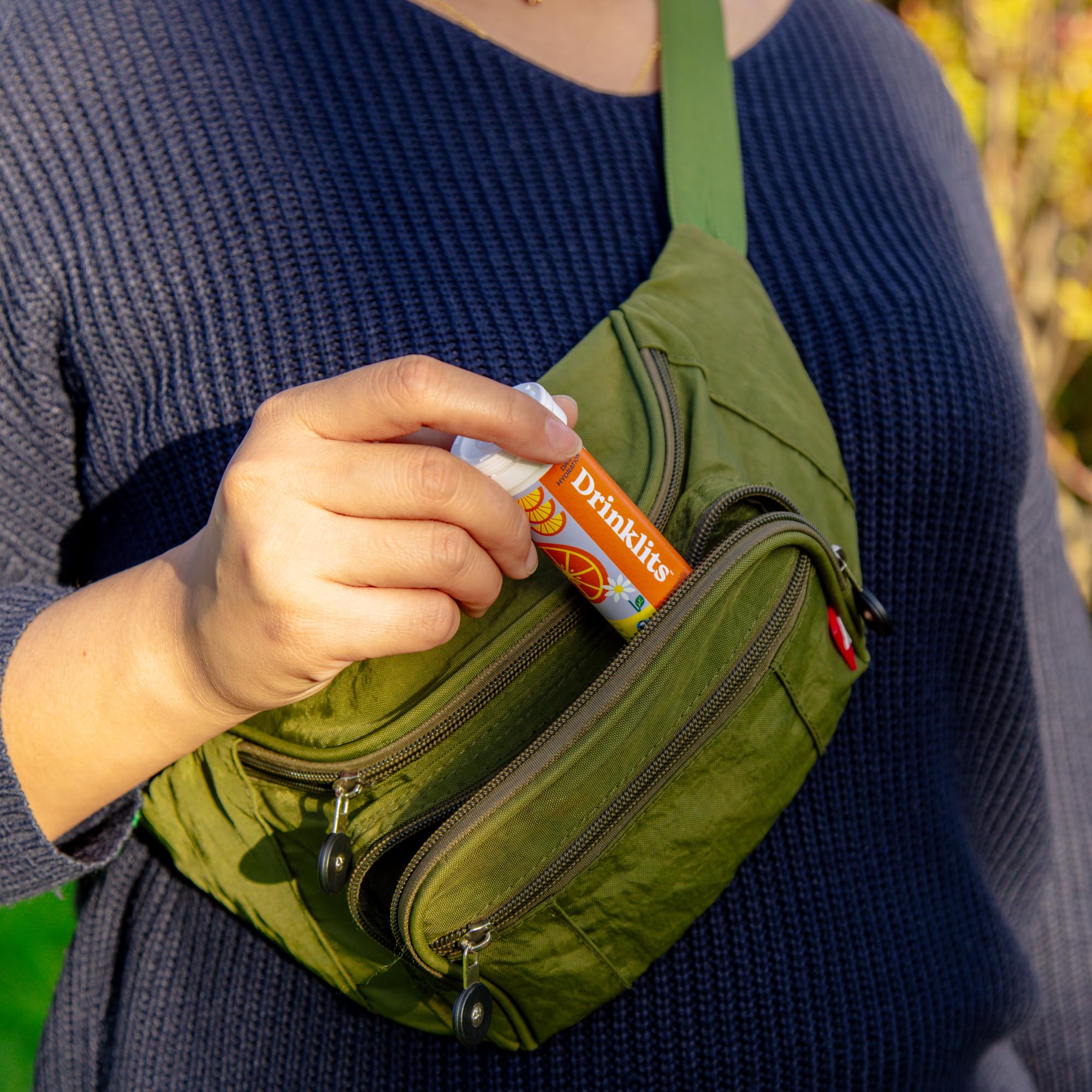Summer travel setup with Drinklits tube beside a reusable bottle