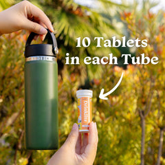 Drinklits tablet close-up with fizz bubbles, highlighting refreshing flavor.