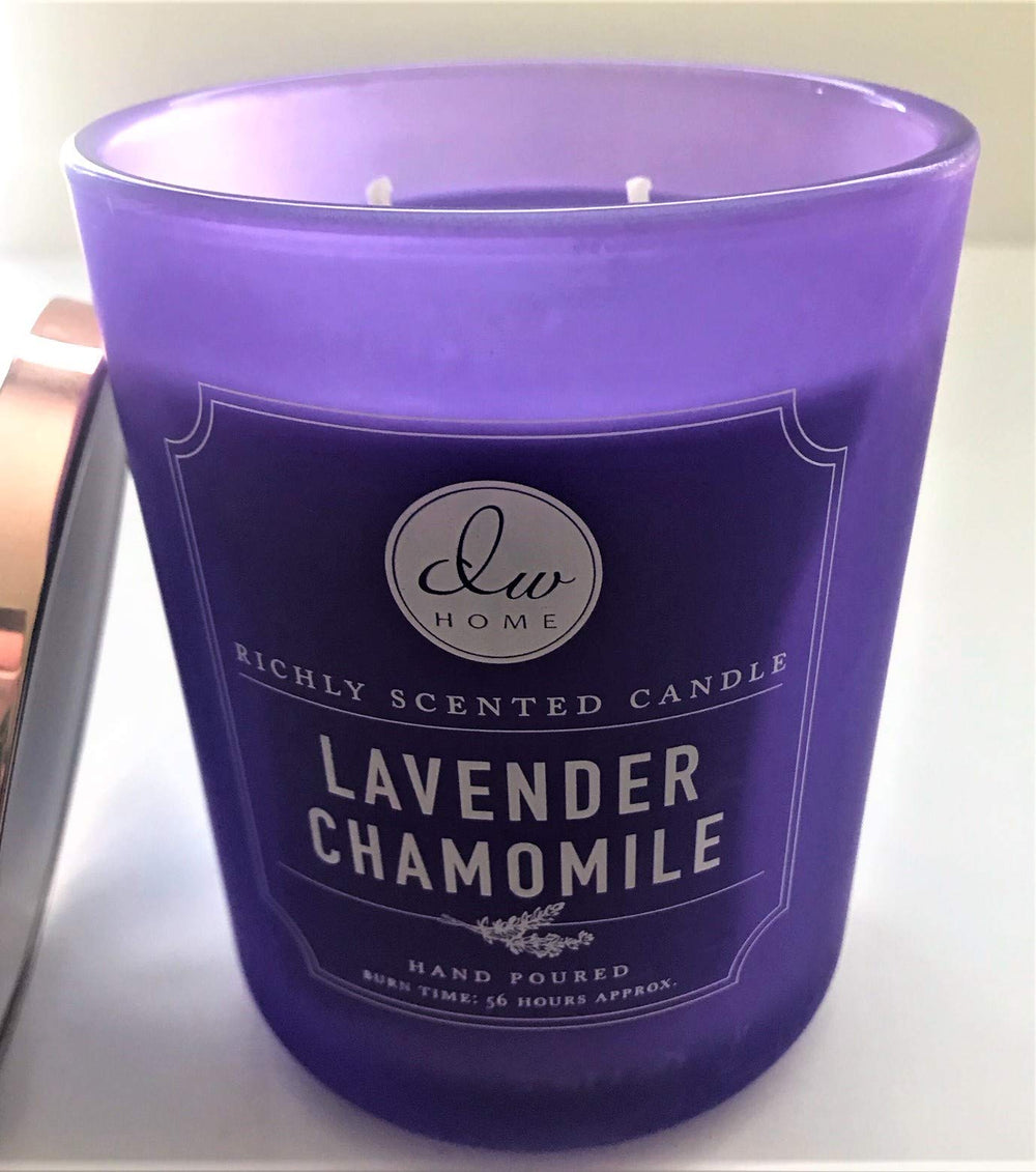 DW Home lavender chamomile candle on table enhancing relaxing ambience with bergamot notes.