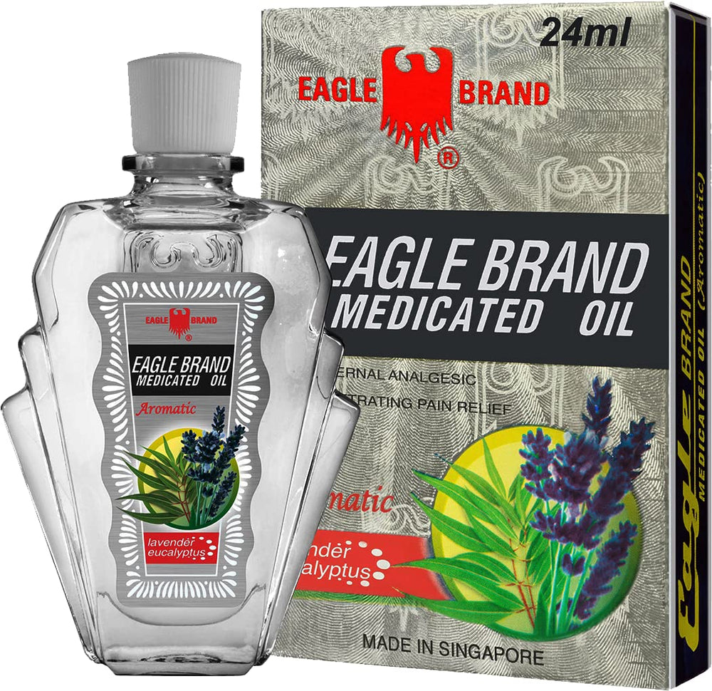 Hands applying Eagle Brand oil for a calming aromatherapy moment