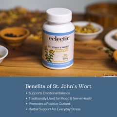 Eclectic Institute St. John's Wort capsules on wooden table, vibrant golden color.