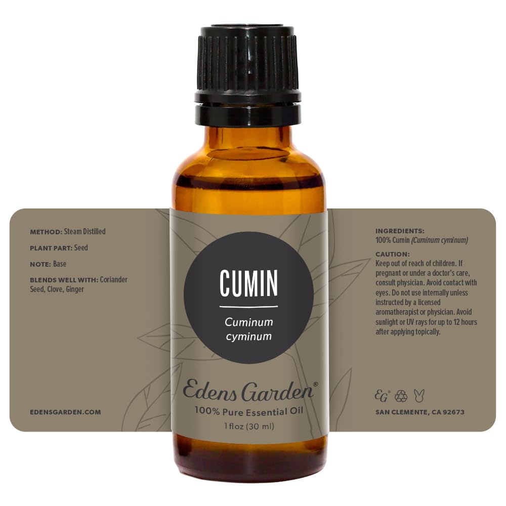Edens Garden cumin essential oil packaging beside aromatherapy accessories.