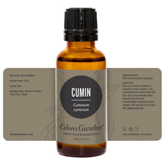 Edens Garden cumin essential oil packaging beside aromatherapy accessories.