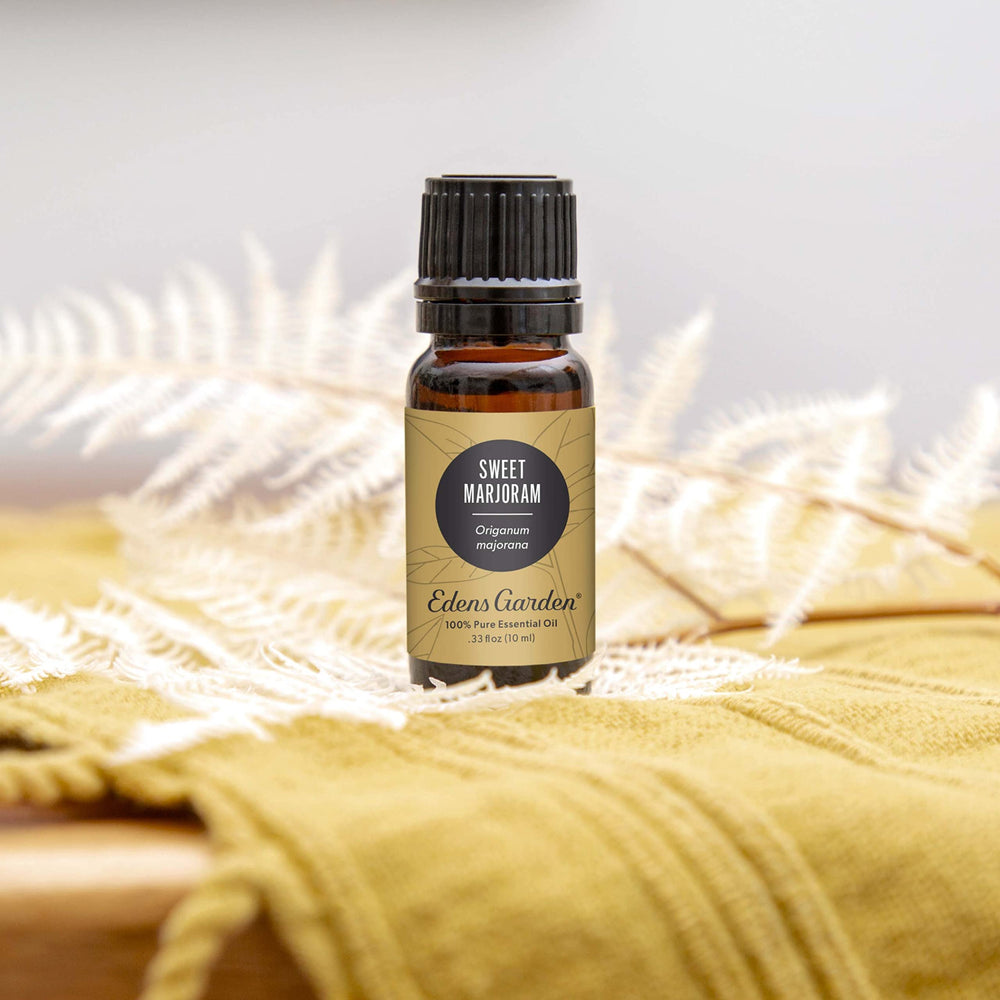 Pouring Edens Garden Sweet Marjoram oil to prepare a massage blend.