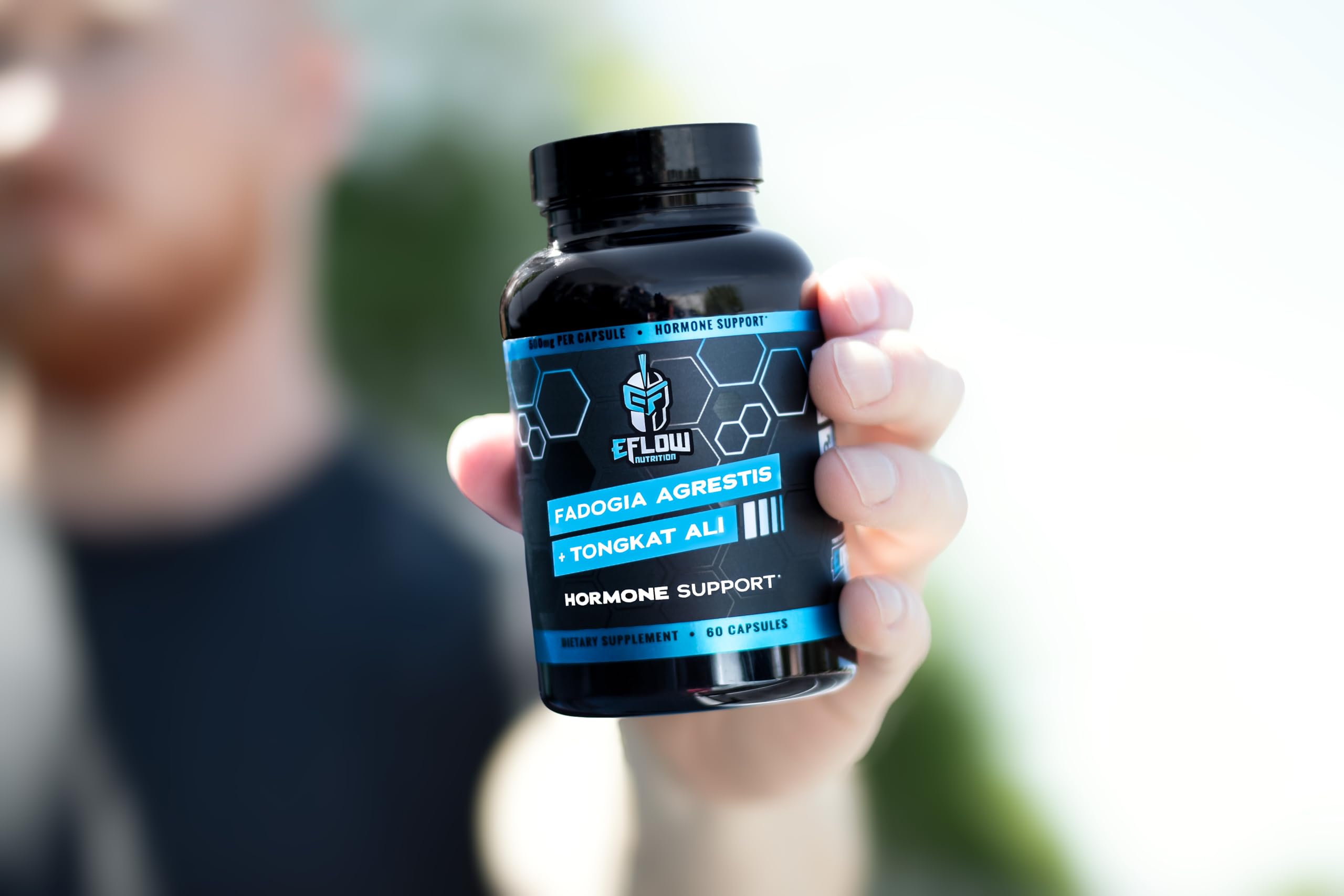 Person taking eFlow capsules as part of a pre-workout routine