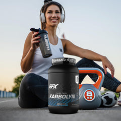EFX Sports Karbolyn Fuel on a desk next to workout gear for pre-workout use