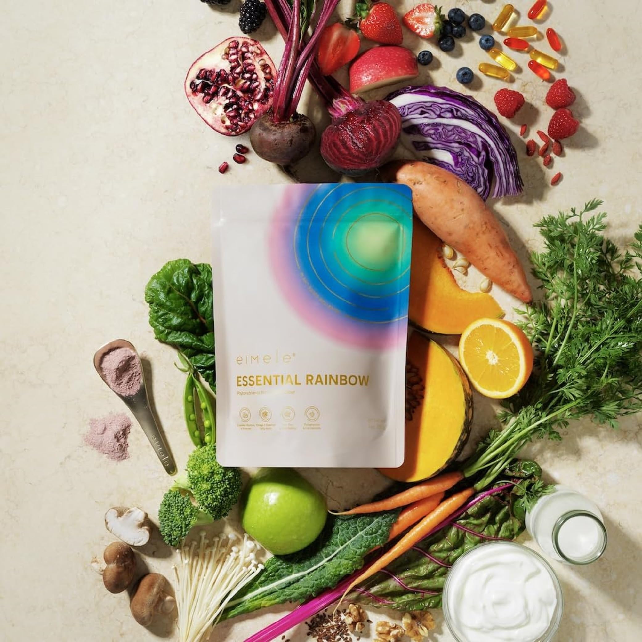 eimele Essential Rainbow scoop dispensing a daily serving.