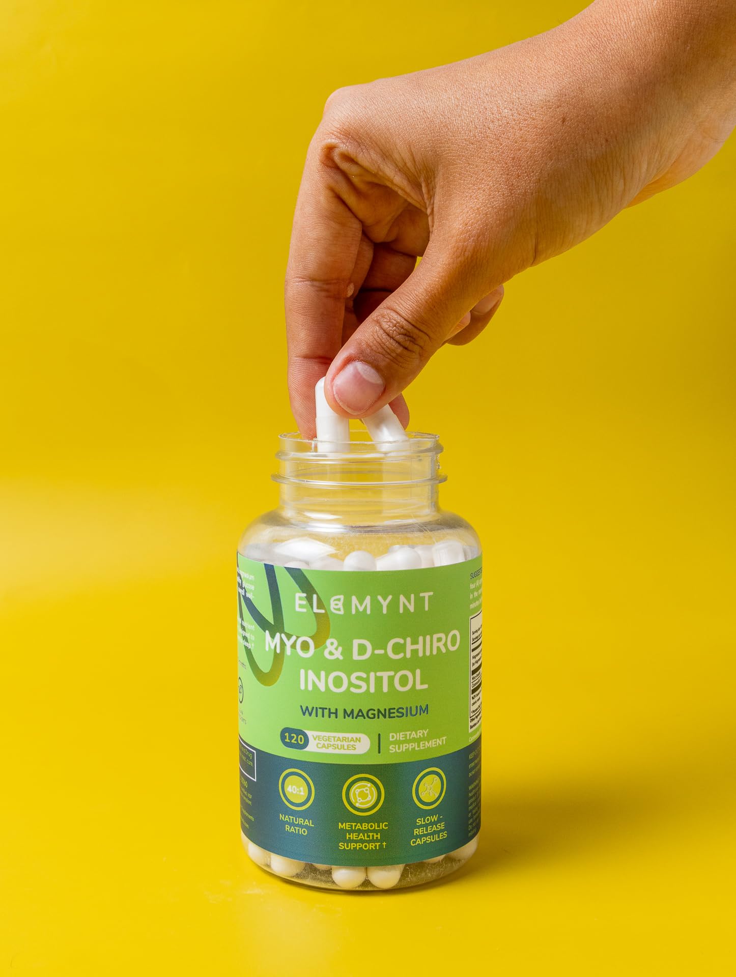Vegan non-GMO seal on ELEMYNT bottle for plant-based wellness