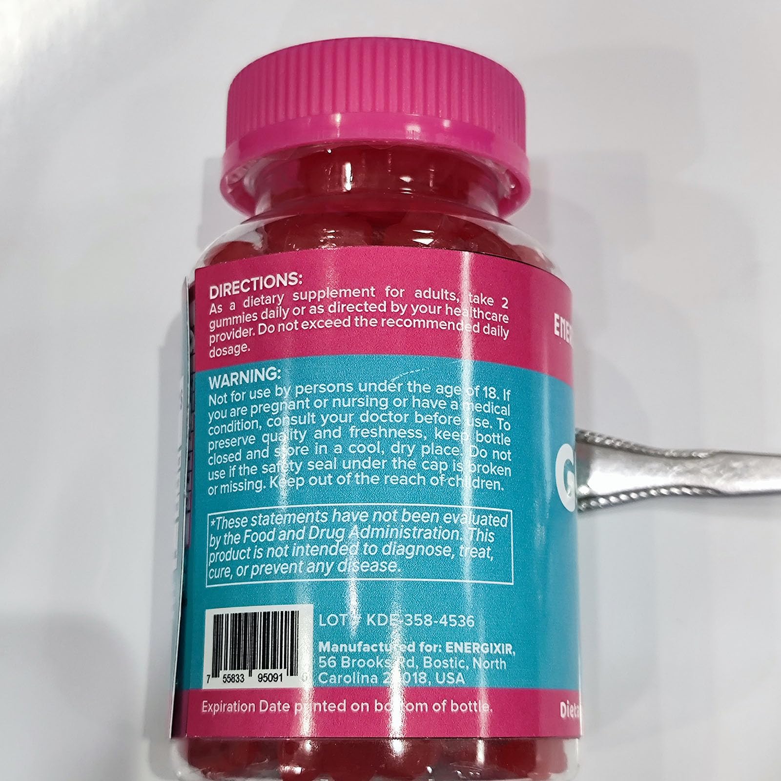 Energixir Creatine Gummies bottle with soft glow for premium supplement feel.