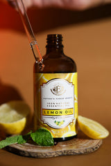 Lemon essential oil added to a diffuser for a refreshing home ambiance.