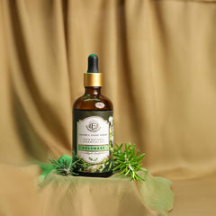Close-up of Enhanced Essentials rosemary oil with glass dropper for precise dilution and application.