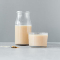 Erbology powder in a cup; versatile addition to beverages and yogurt.