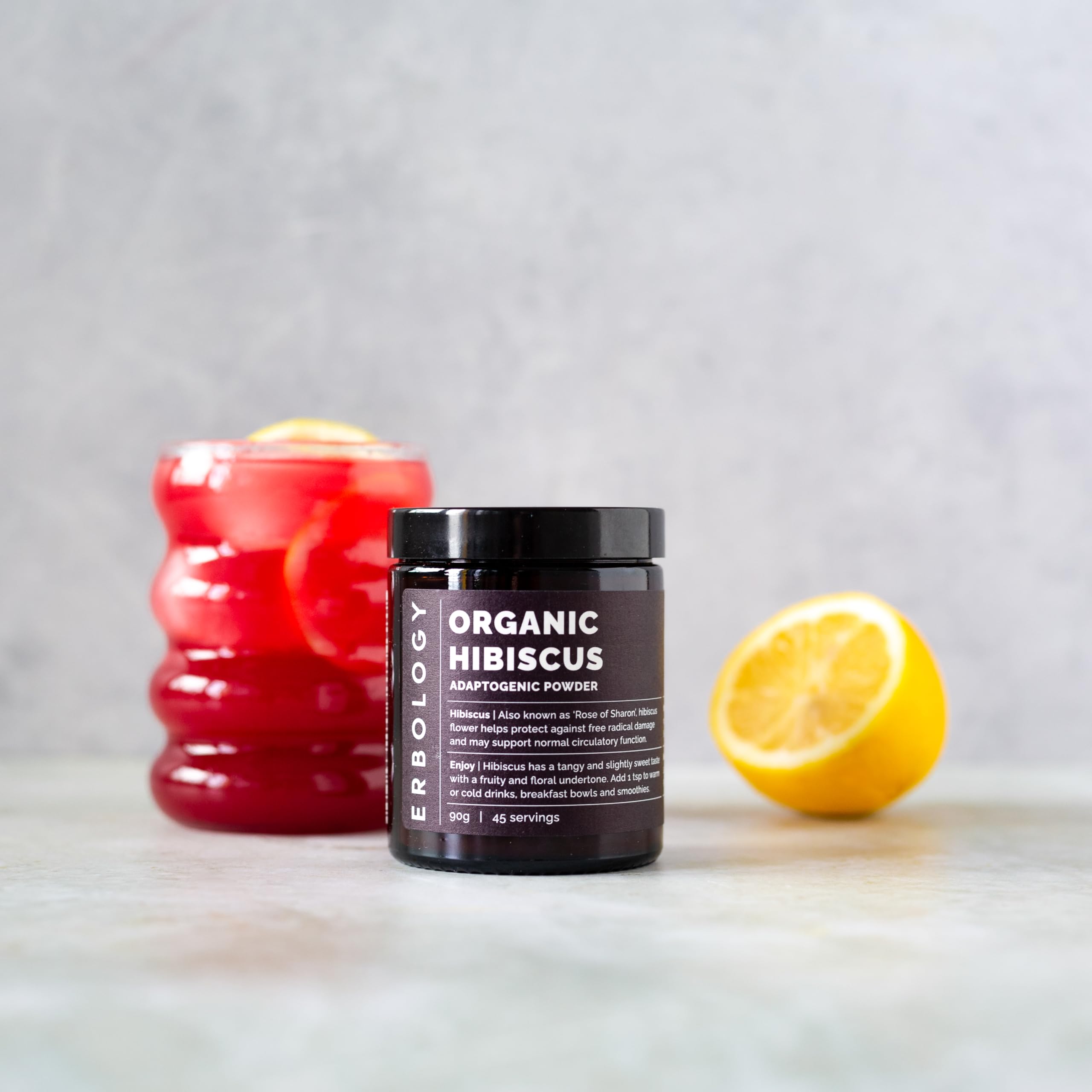 Erbology hibiscus drink in glass shows bright color and aroma