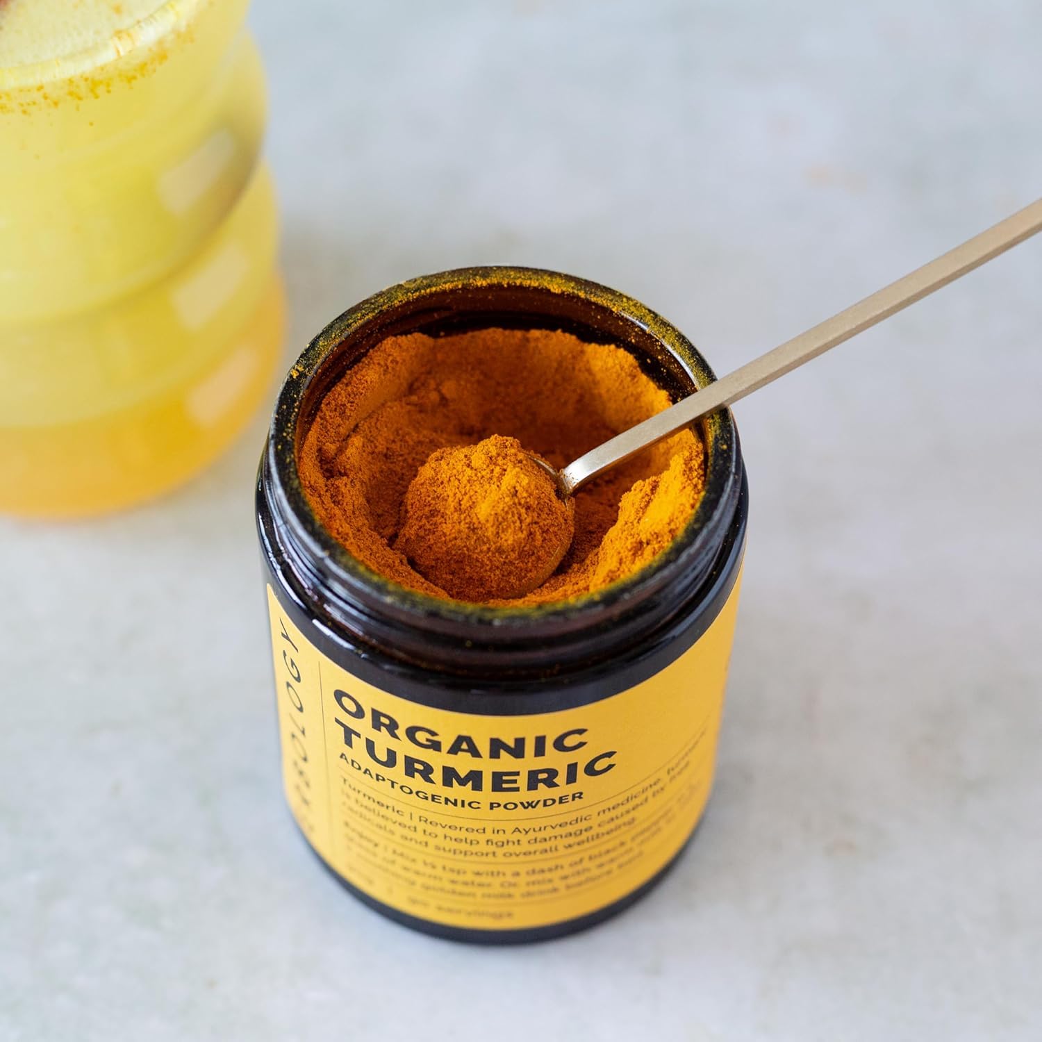 Erbology turmeric powder in golden milk scene with warm glow