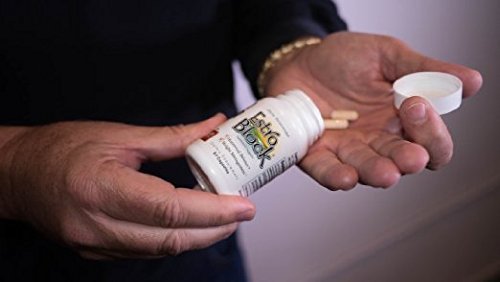 Estroblock capsules in hand illustrate portable daily supplement