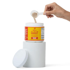 Powder mix in a glass with Ethan's Feel Good orange mango flavor for hydration.