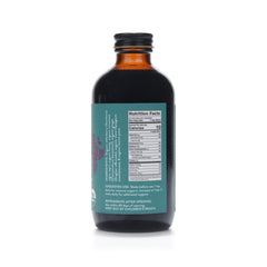 Fields Without Fences Elderberry Elixir ingredients close-up: organic elderberries, honey, cinnamon, ginger, clove.