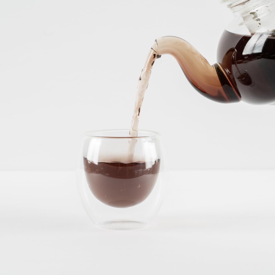 Food Over Drugs detox tea brewed in glass cup suggests a soothing daily ritual.