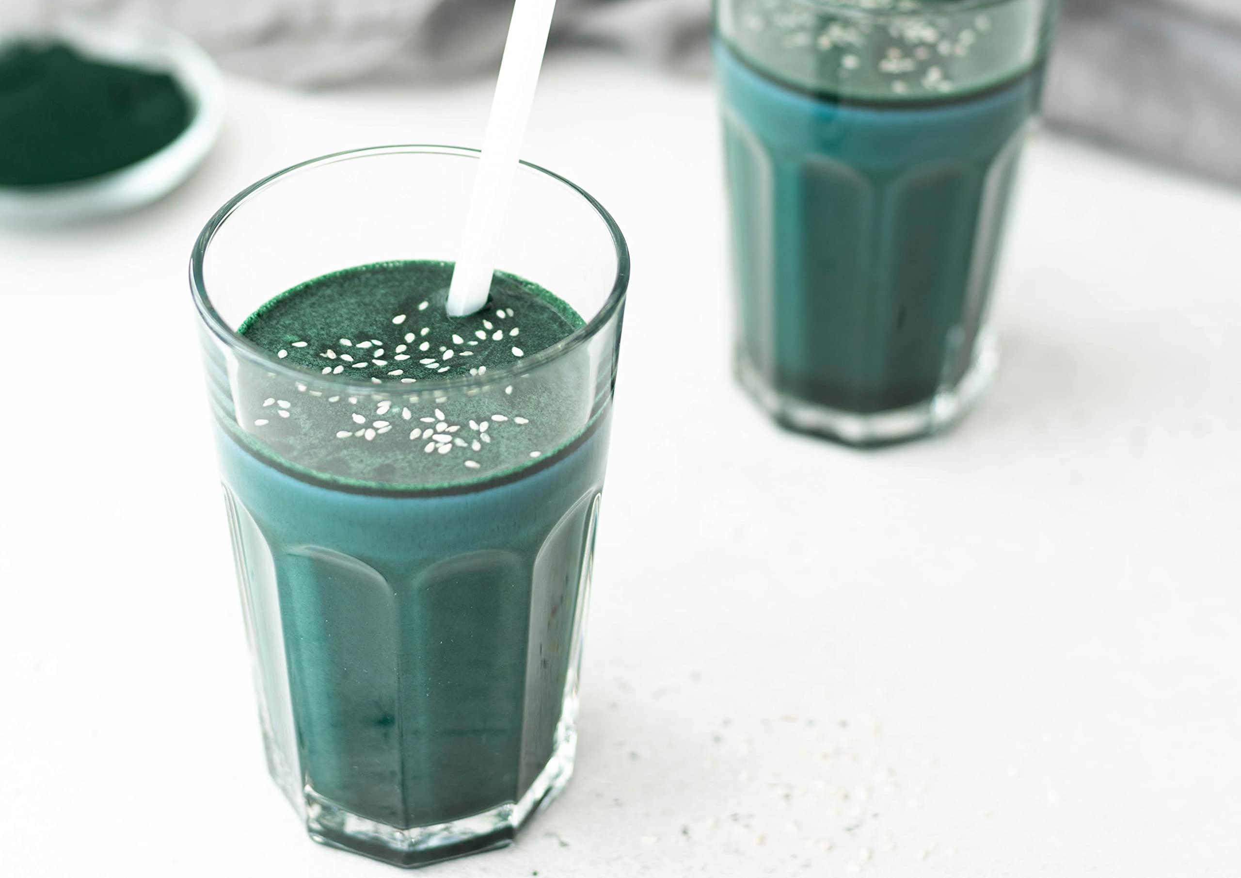 Food to Live algae powder in a glass smoothie for a vibrant drink.