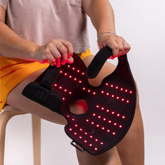 Fringe red light therapy wrap on hand offers comforting warmth and relief.