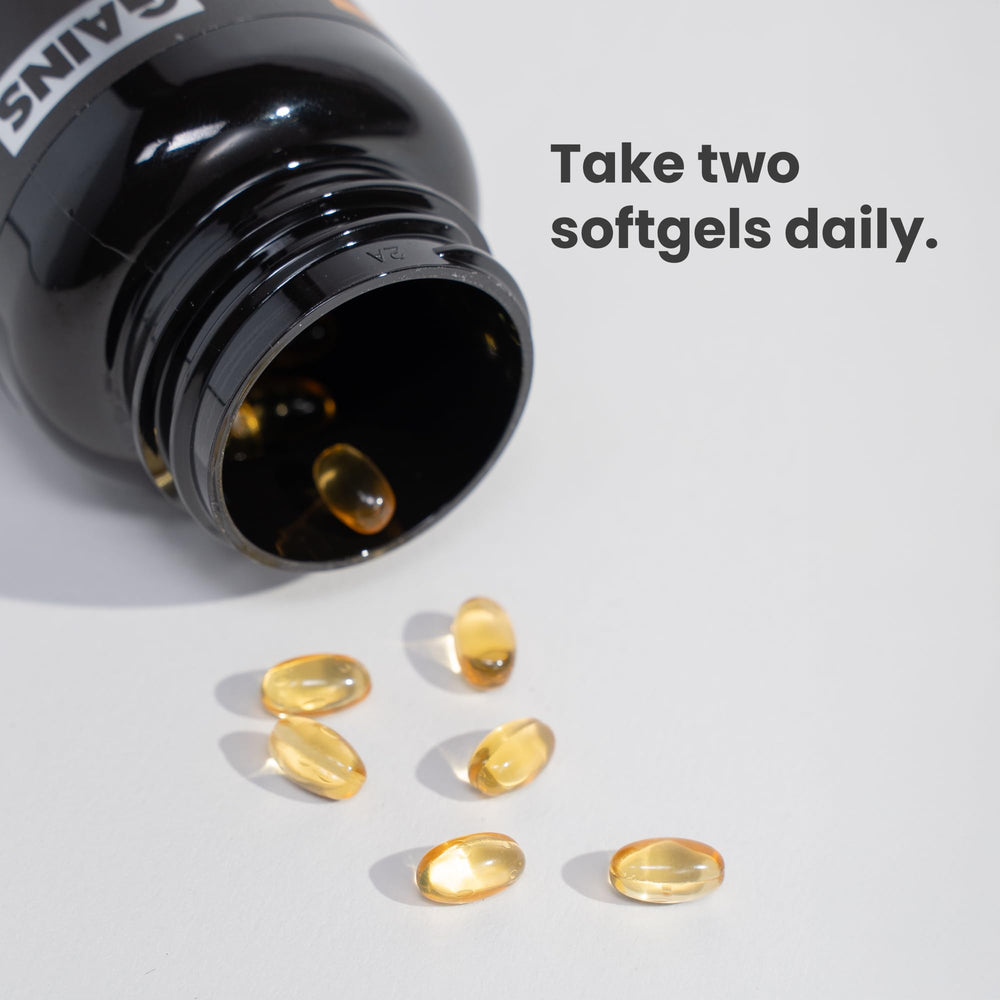 GAINS IN BULK softgels in hand illustrate simple daily intake.