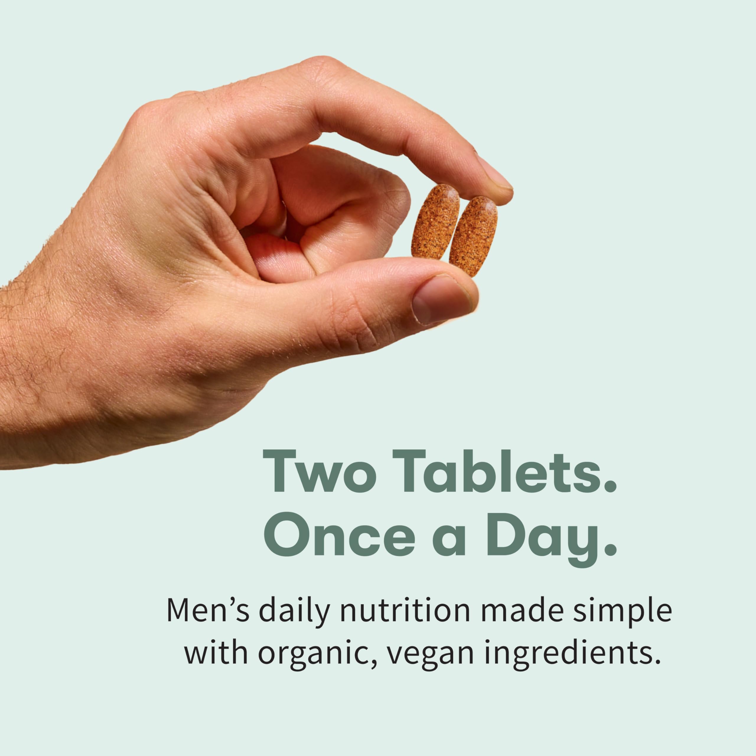 Garden of Life Organics Men 40+ tablets in hand suggest daily wellness routine.