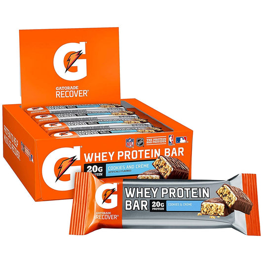 Athlete holding a cookies & creme bar for quick recovery