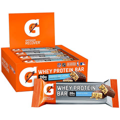Athlete holding a cookies & creme bar for quick recovery
