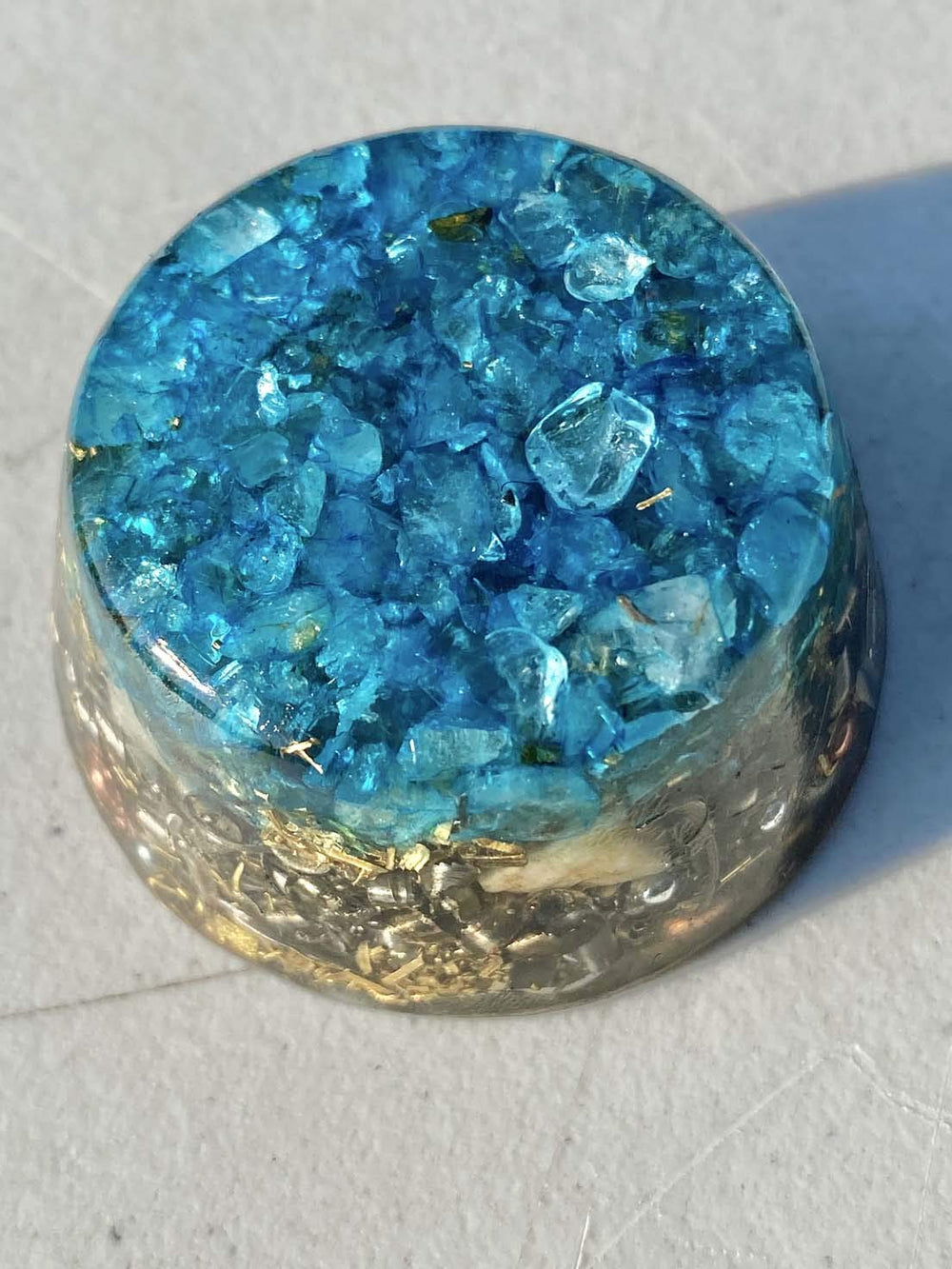 Generic Blue Topaz single crystal tower buster orgonite on display for ambient energy and decor