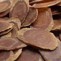 Generic dried red ginseng slices stack on plate for cooking.