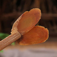 Generic natural ginseng root slices raw texture ready for infusion.