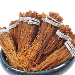 Thinly sliced red ginseng prepared for stewing in pot.