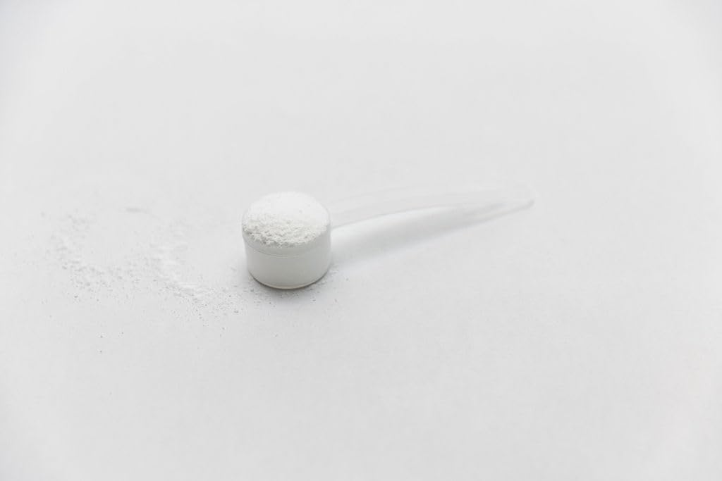Genetic Edge Compounds Creatine HCl + HMB glass of water ready to mix.