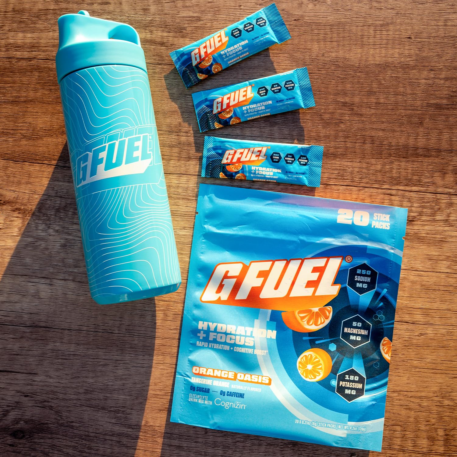 G Fuel Electrolytes Orange Oasis bottle on a desk during study or workout.