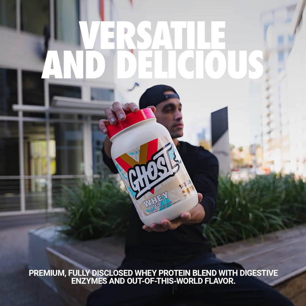 Scoop pouring into glass, showcasing 26g protein per serving.