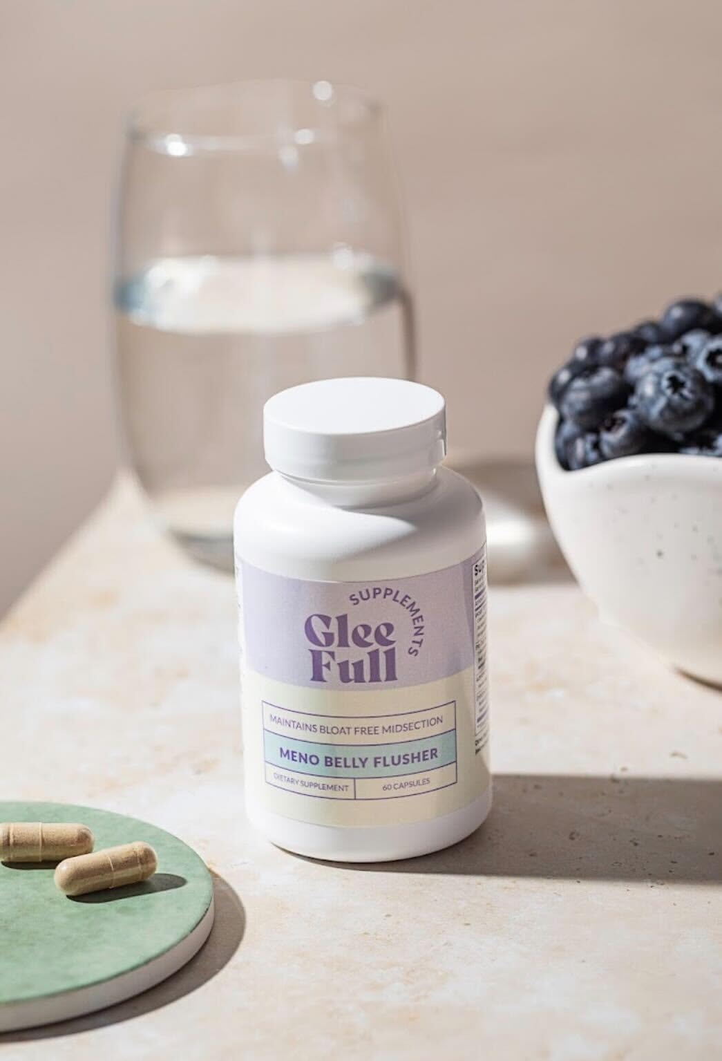 GLEEFULL SUPPS Meno Belly Flusher capsule scene emphasizing menopause-supportive gut wellness.
