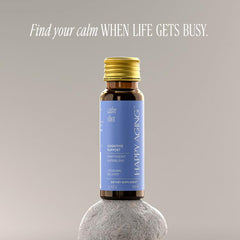 Happy Aging Cortisol Shots glass on counter highlights quick, calming intake during hectic moments.