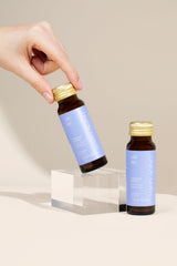 Happy Aging Cortisol Shots on nightstand scene suggests sleep-friendly support after busy days.