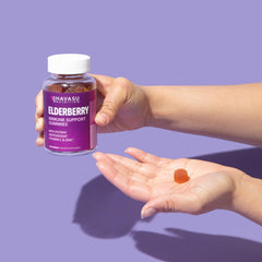 Hand holding HAVASU Sambucus Elderberry Gummies bottle for on-the-go use