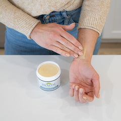 Health As It Ought To Be magnesium body balm application on shoulder demonstrates easy muscle relief.
