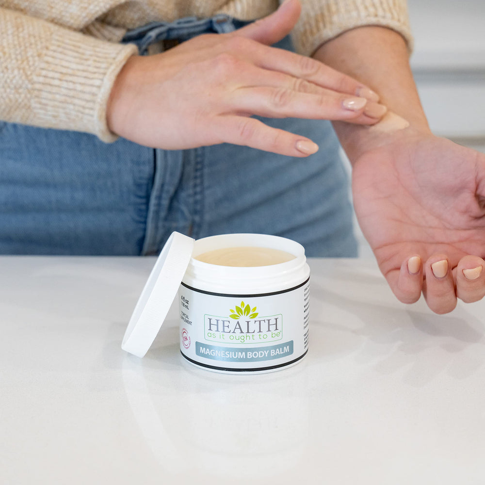 Health As It Ought To Be magnesium body balm jojoba coconut oil close-up shows creamy, hydrating formula.