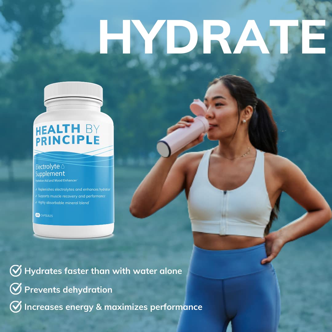 Health by Principle electrolyte capsules pouring from bottle illustrating convenient daily hydration.
