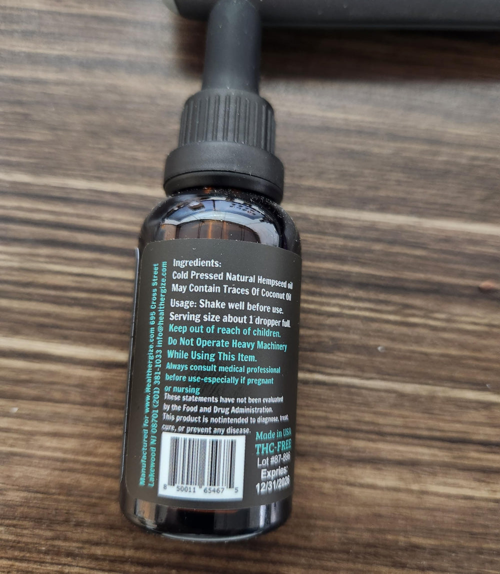 Dropper applying Healthergize hemp oil to skincare routine.