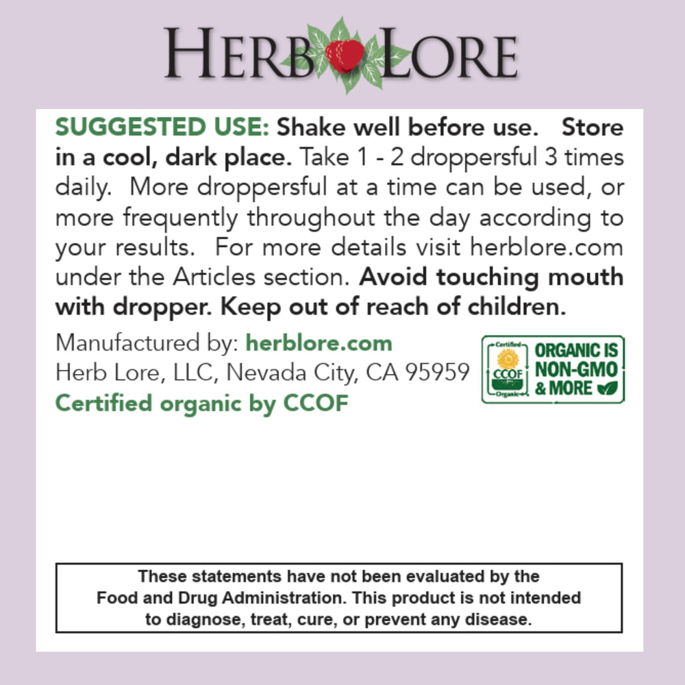 Hand holding dropper releasing tincture into a glass for easy dosing with Herb Lore.