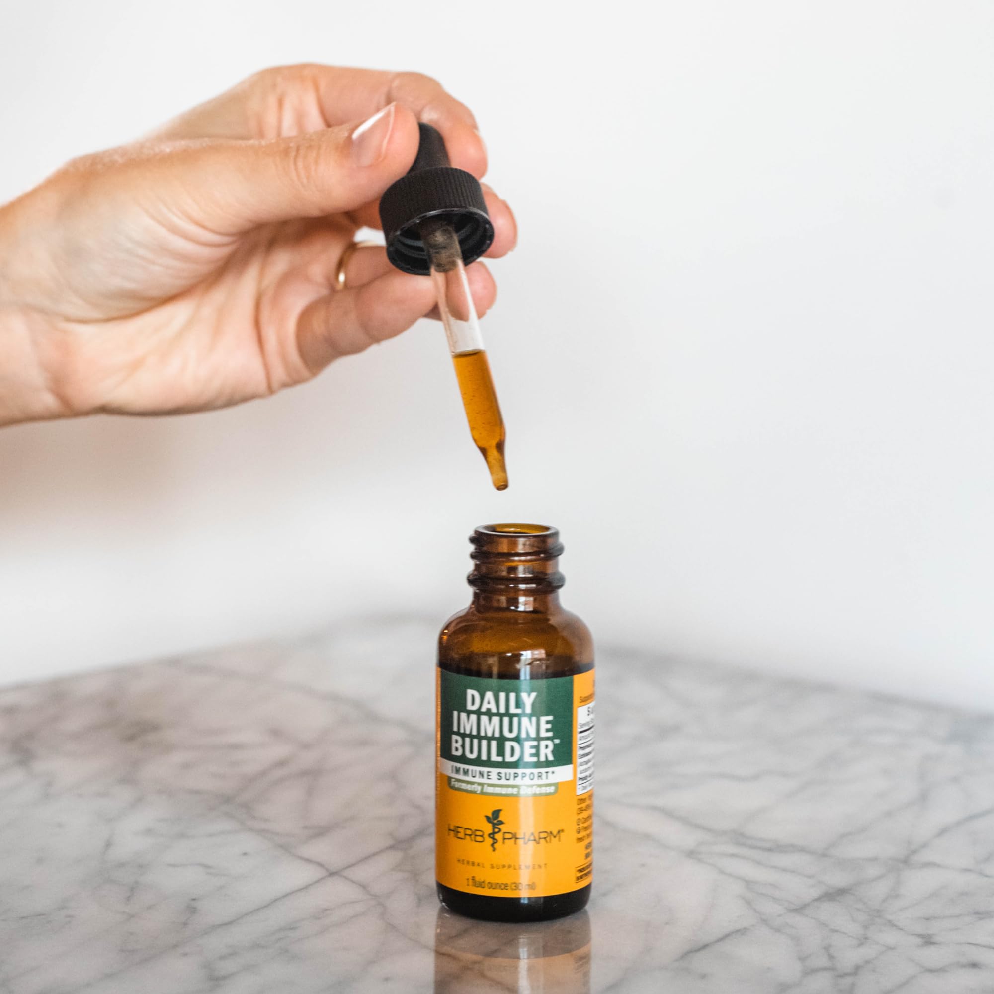 Herb Pharm Daily Immune Builder dropper action demonstrates precise dosing.