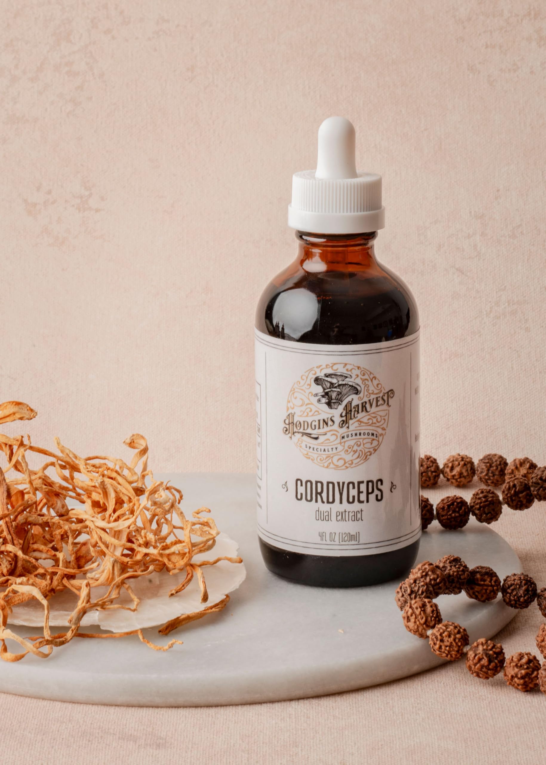 Hodgins Harvest tincture poured into glass shows deep, rich color